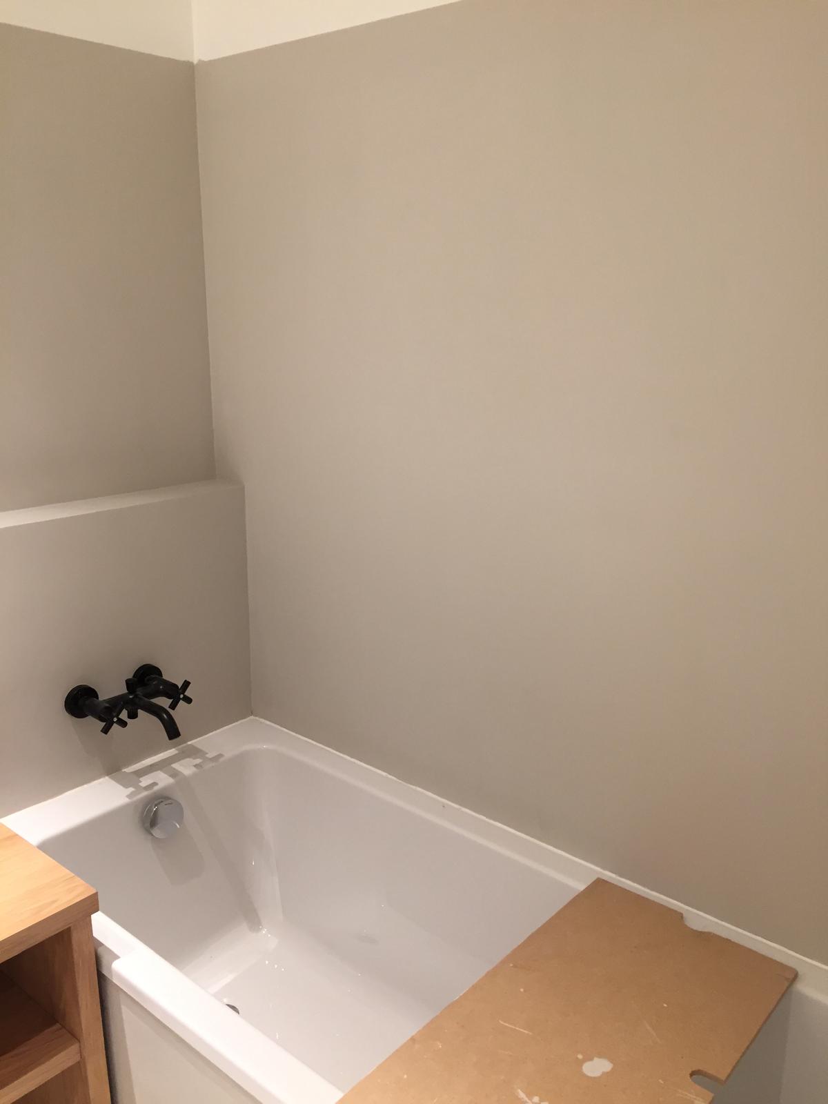 residential microcement wall in a bathroom with a tub