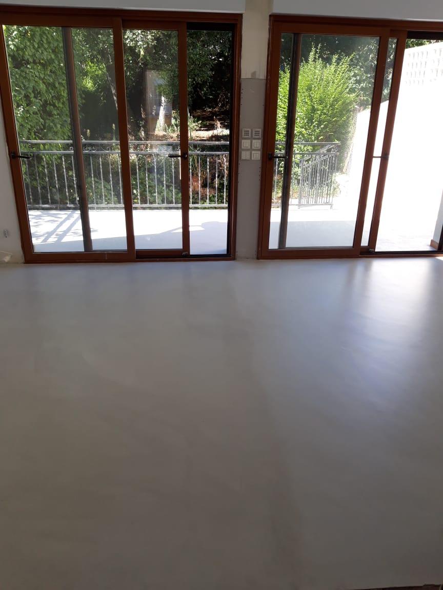 Residential microcement flooring with patio sliding doors